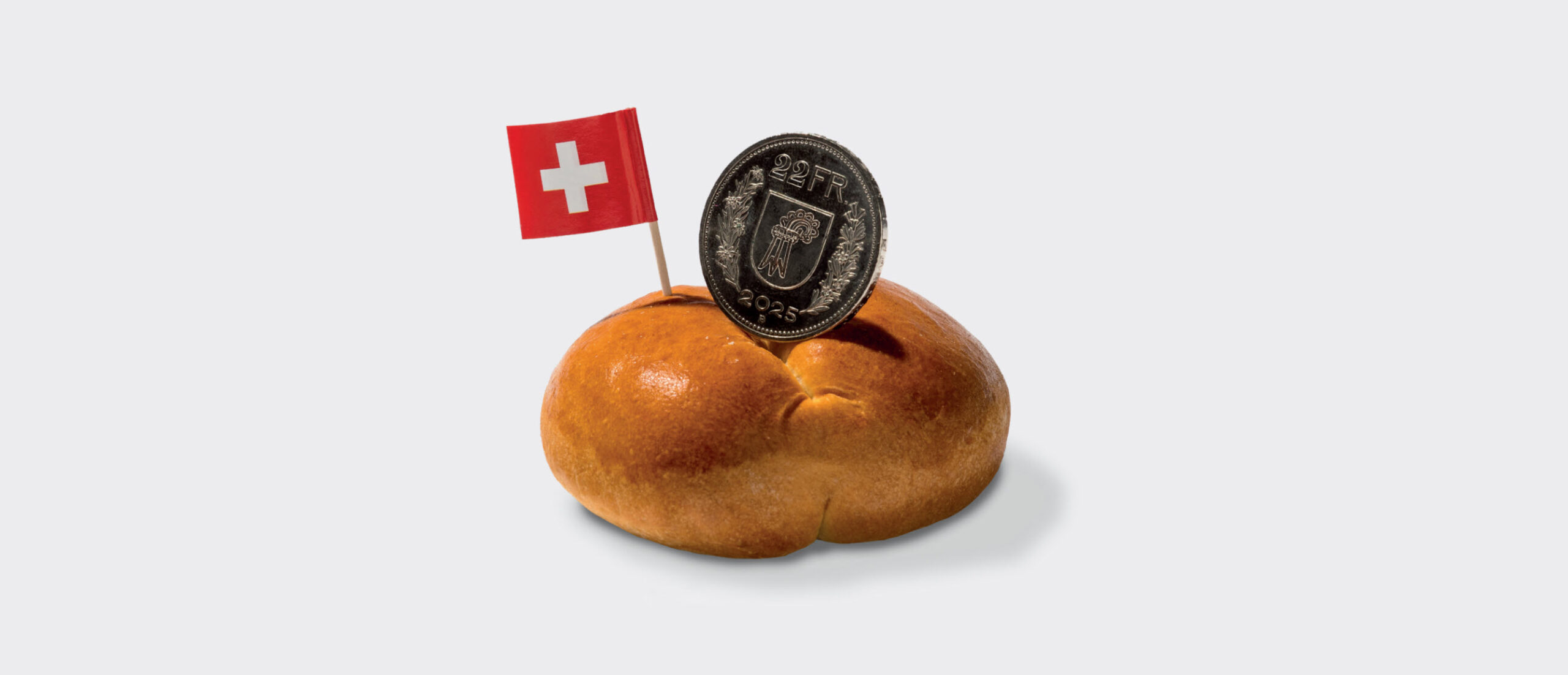 Abstimmungssujet der Inititiative Mindestlohn Baselland mit einem Weggli und einem Fünflieber, der 22 Franken aufgeprägt hat